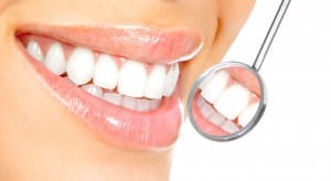 Women's teeth with a small dental mirror, Foundations of Health Dental Care, Dentist St. Joseph, MO