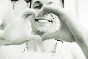 Man signaling love with hands, Foundations of Health Dental Care